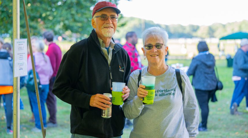 A man and woman standing next to each other at an outdoor event.
