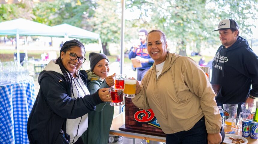 A group of people drinking beer at an outdoor event.