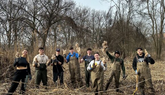 People in waders in a wetland