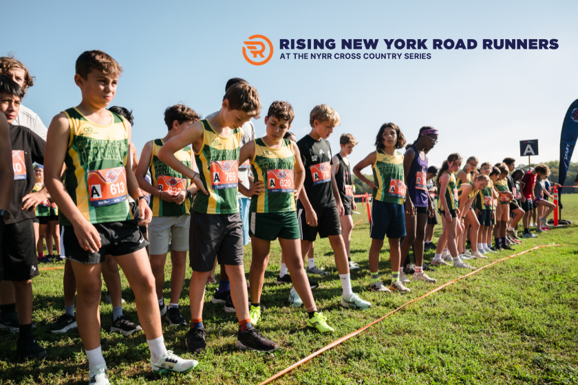 A line up of kids in shirts and shorts getting ready for a race.